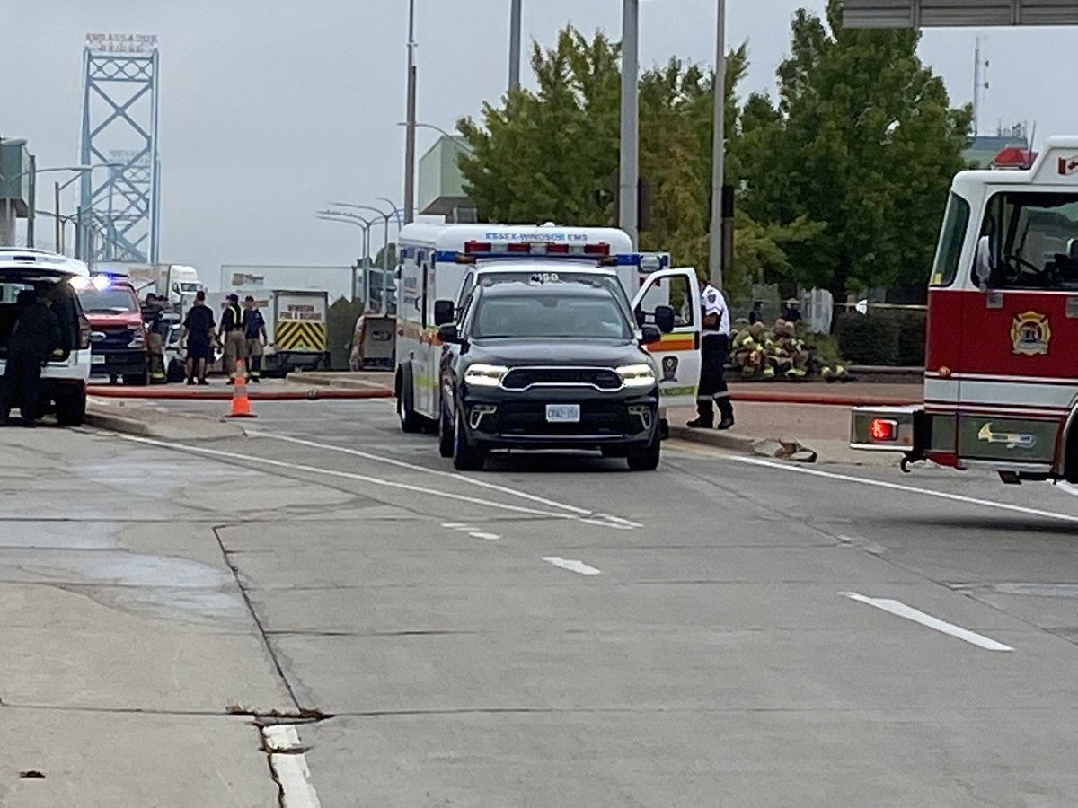 Here's the view from the other side  dozens of emergency crews blocking the road where traffic would exit the Ambassador Bridge.   One fire truck has its hose connected and out across the roadway.   Windsor police also has a large truck set up, many paramedics on scene
