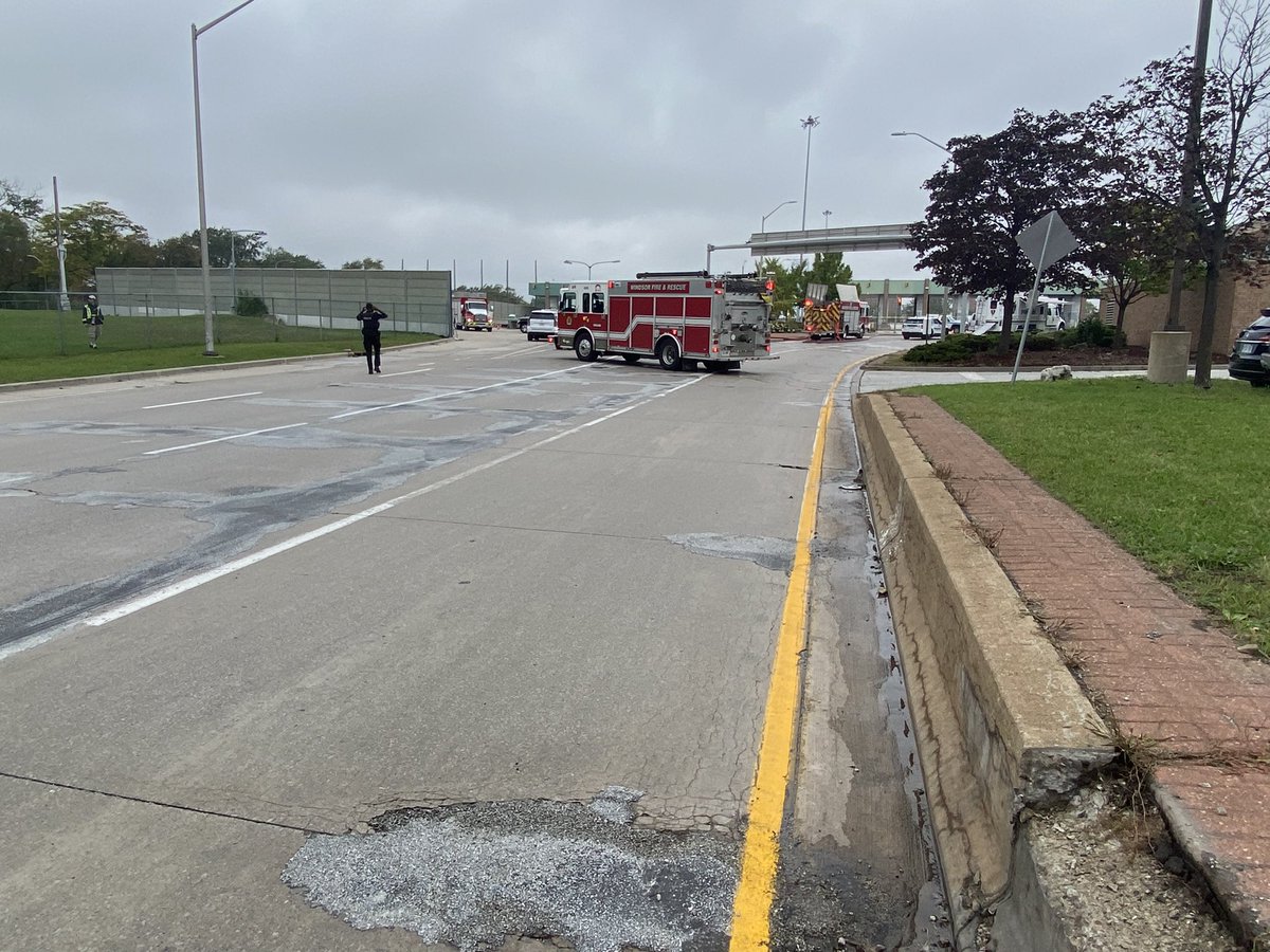 Here's the view from the other side  dozens of emergency crews blocking the road where traffic would exit the Ambassador Bridge.   One fire truck has its hose connected and out across the roadway.   Windsor police also has a large truck set up, many paramedics on scene