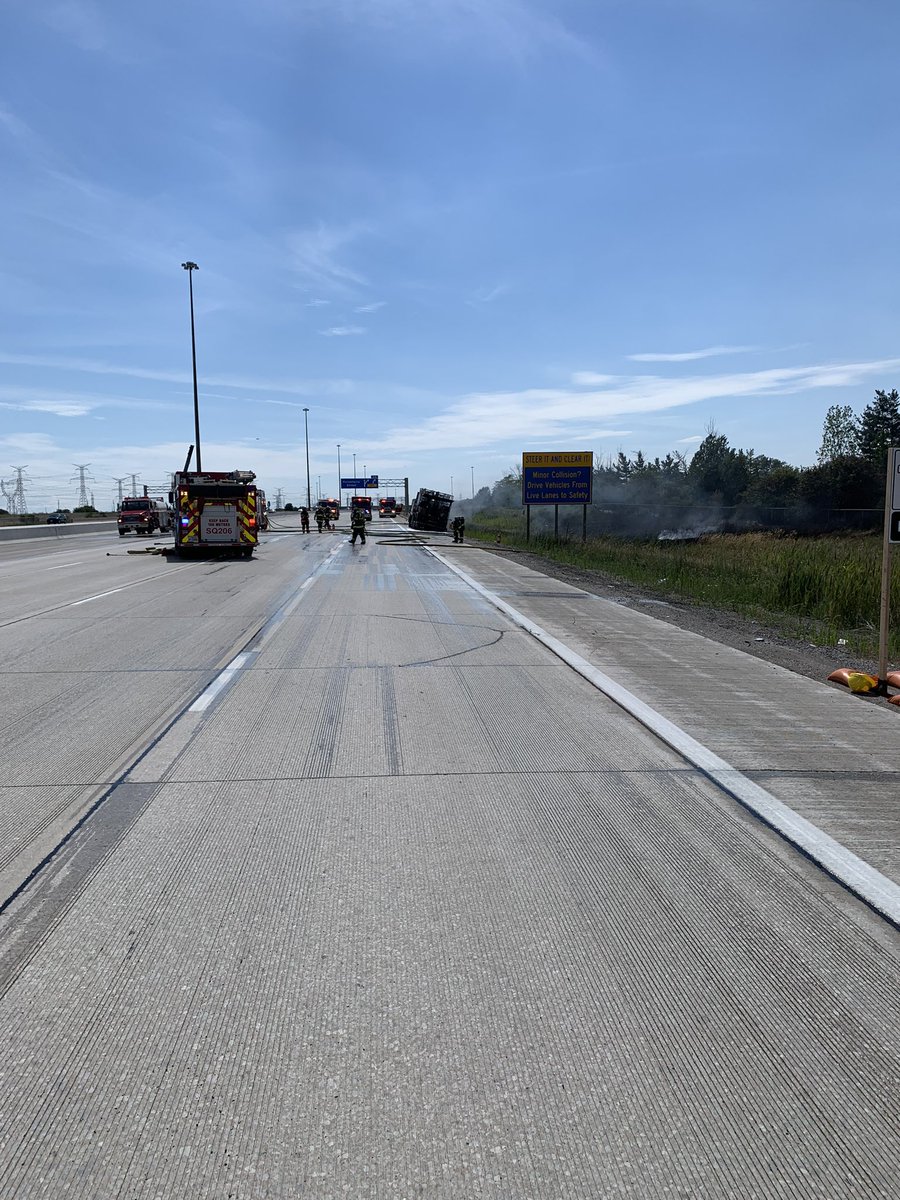 Cene of truck and grass fire on @407ETR WB east of Hurontario St. All lanes have been booked while crews work to extinguish the fire.